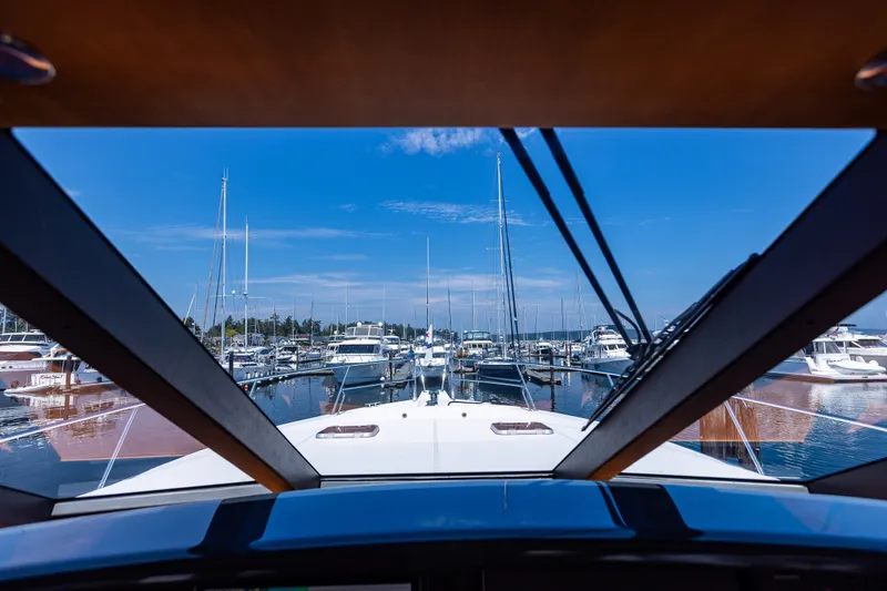Slide: The Image of View from 2005 West Bay 86 Raised Pilothouse Motor Yacht in marina, clear blue sky. - 38