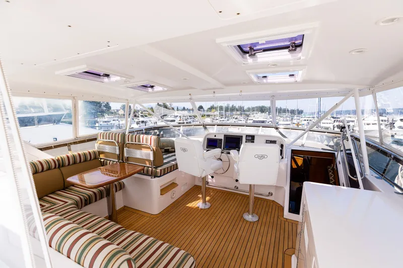 Slide: The Image of Luxurious 2005 West Bay 86 Raised Pilothouse Motor Yacht interior with striped seating and helm. - 94