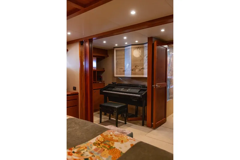 Slide: The Image of Luxurious interior of 2005 West Bay 86 Yacht featuring a piano and elegant wood finishes. - 65