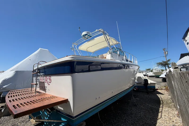 Slide: The Image of 1985 Formula 31 Performance Cruiser boat on dry dock under clear blue sky. - 1
