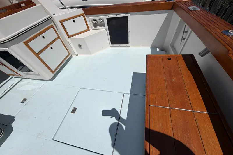 Slide: The Image of 1985 Formula 31 Performance Cruiser cockpit with wooden accents and storage compartments. - 11