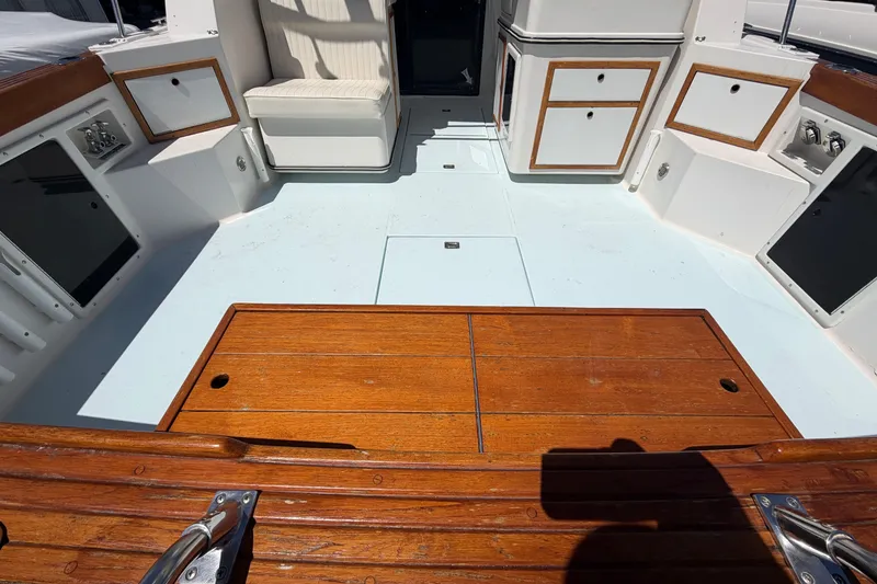 Slide: The Image of 1985 Formula 31 Performance Cruiser cockpit with wooden deck and storage compartments. - 12