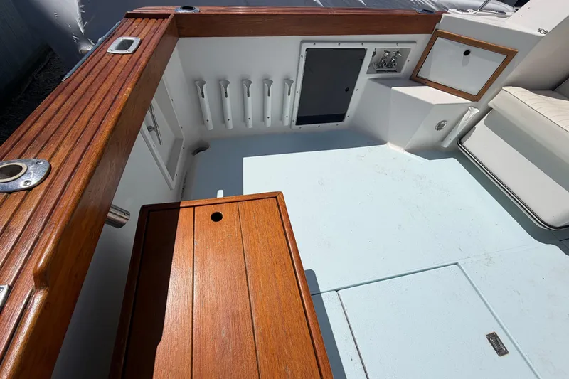 Slide: The Image of 1985 Formula 31 Performance Cruiser cockpit with wood accents and storage compartments. - 13