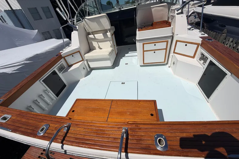 Slide: The Image of 1985 Formula 31 Performance Cruiser boat interior with wood accents and seating. - 14