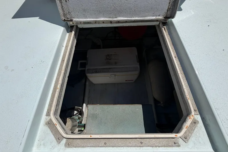 Slide: The Image of Open hatch of a 1985 Formula 31 Performance Cruiser, revealing storage compartment. - 16