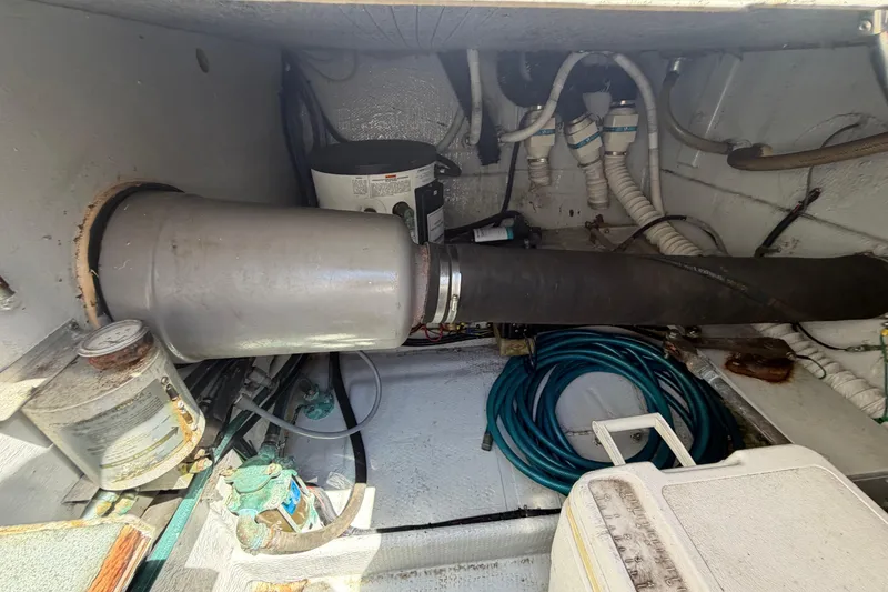 Slide: The Image of Engine compartment of a 1985 Formula 31 Performance Cruiser with hoses and equipment. - 17