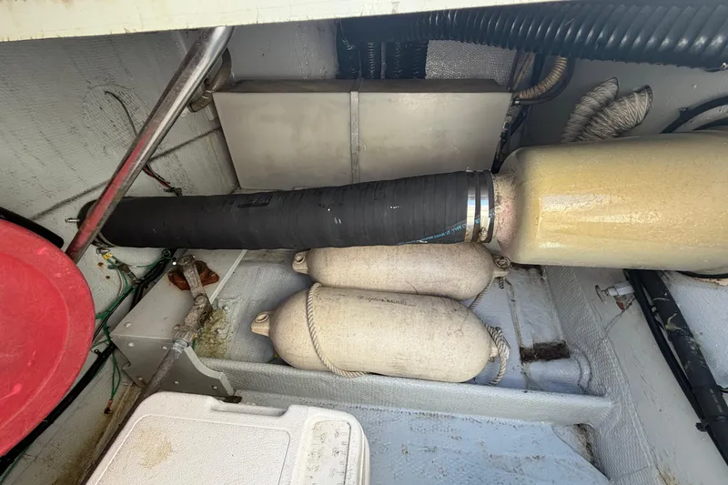 Slide: The Image of Engine compartment of a 1985 Formula 31 Performance Cruiser with visible components and hoses. - 18