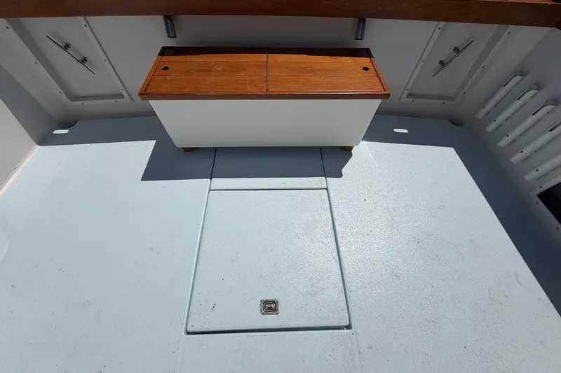 Slide: The Image of 1985 Formula 31 Performance Cruiser interior with wooden storage bench and clean deck. - 19