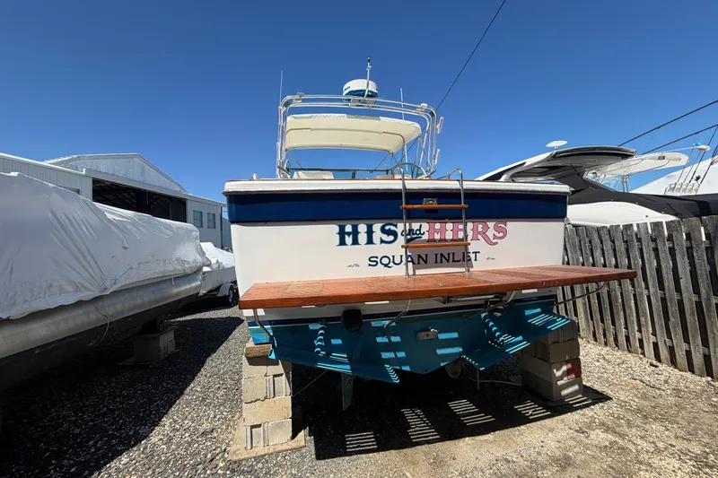 Slide: The Image of 1985 Formula 31 Performance Cruiser boat on blocks, rear view, sunny day. - 2