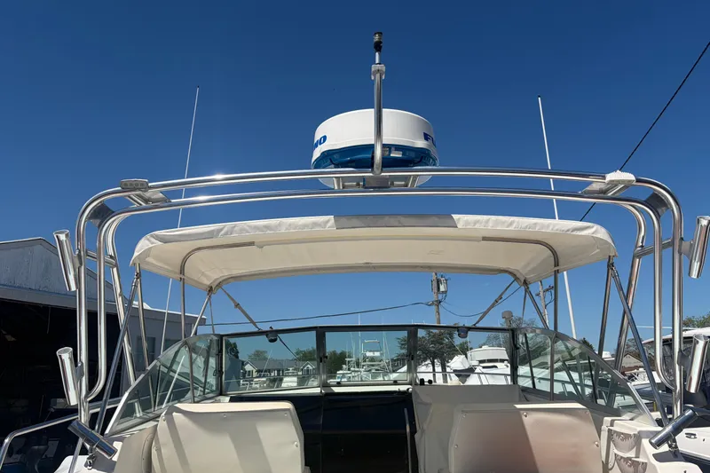 Slide: The Image of 1985 Formula 31 Performance Cruiser boat with radar, docked under clear blue sky. - 21