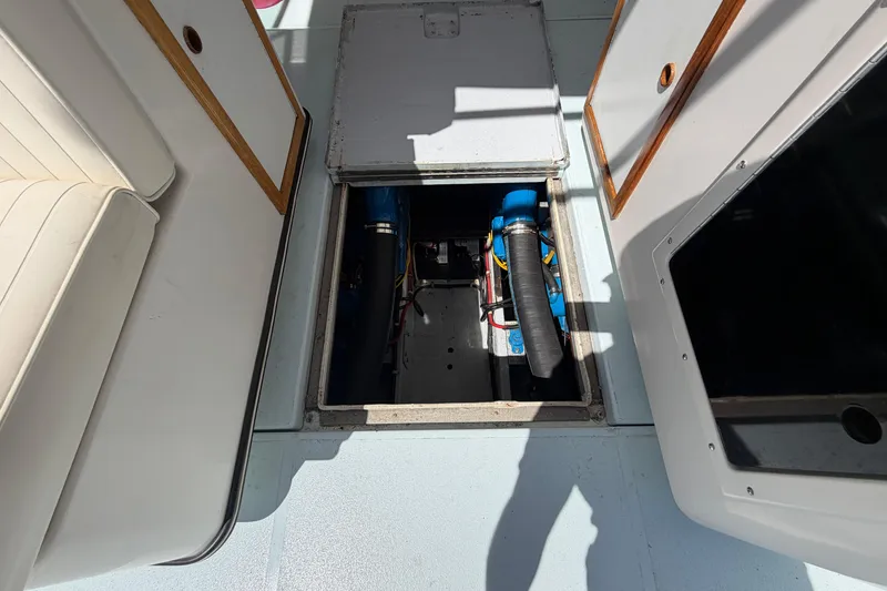 Slide: The Image of 1985 Formula 31 Performance Cruiser engine compartment with visible wiring and components. - 22