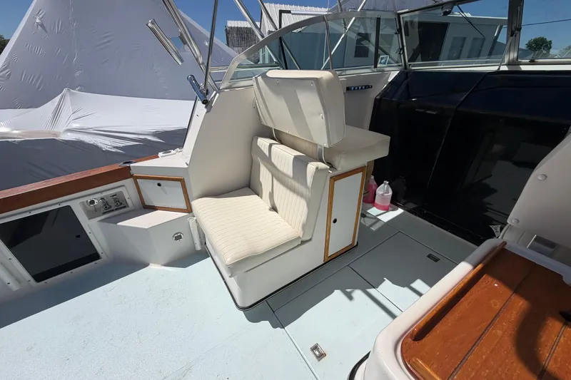 Slide: The Image of 1985 Formula 31 Performance Cruiser cockpit with white seating and control panel. - 23