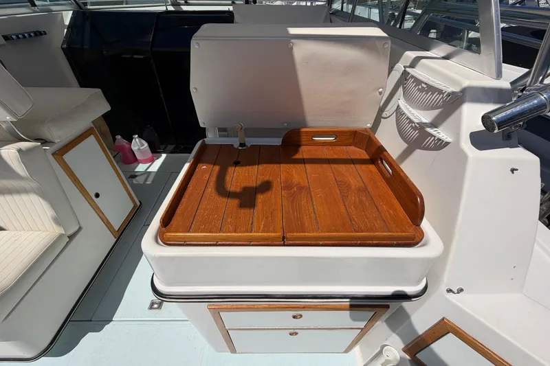 Slide: The Image of 1985 Formula 31 Performance Cruiser interior with wooden tray and seating area. - 26