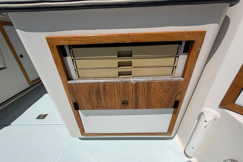 Slide: The Image of 1985 Formula 31 Performance Cruiser interior with wooden storage compartments. - 28