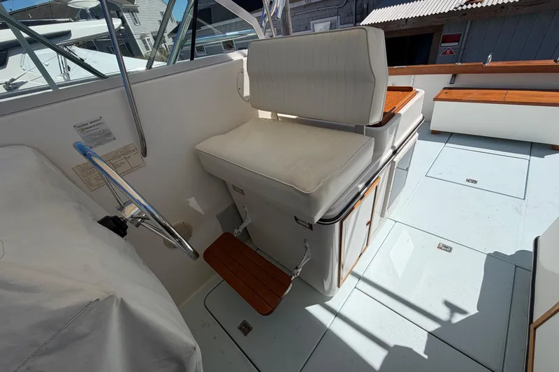 Slide: The Image of 1985 Formula 31 Performance Cruiser cockpit with cushioned seating and wooden accents. - 29