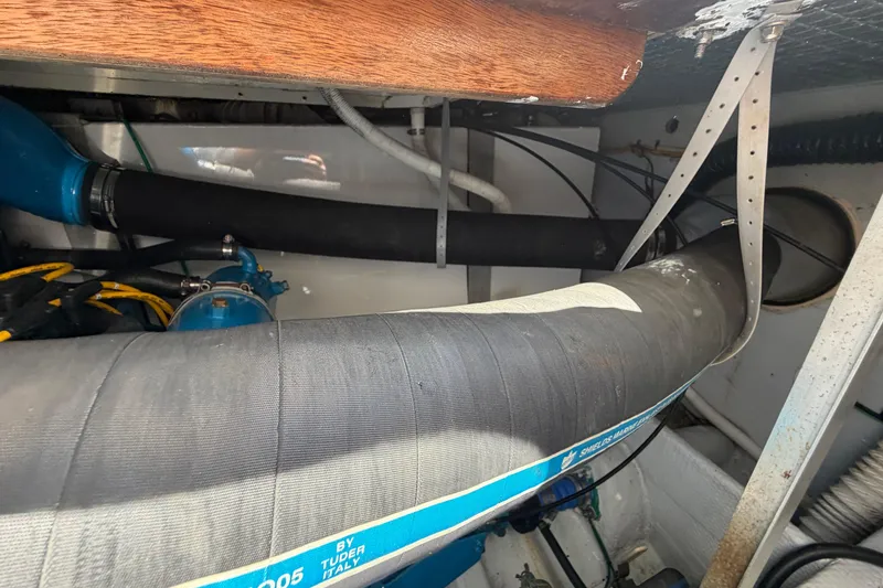 Slide: The Image of Engine compartment of a 1985 Formula 31 Performance Cruiser with hoses and fittings. - 31