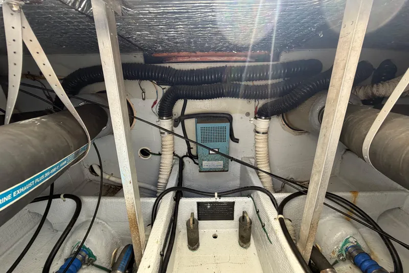 Slide: The Image of Engine compartment of a 1985 Formula 31 Performance Cruiser with visible hoses and wiring. - 33