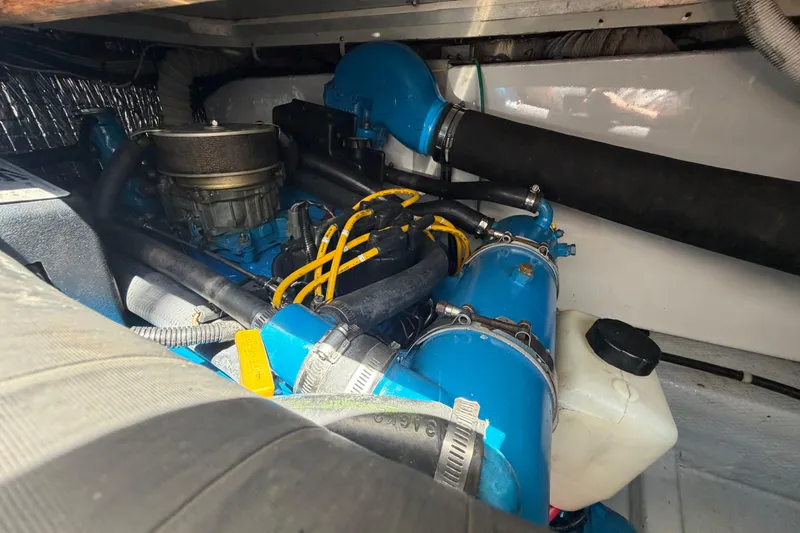 Slide: The Image of Engine compartment of a 1985 Formula 31 Performance Cruiser, featuring blue components and hoses. - 34