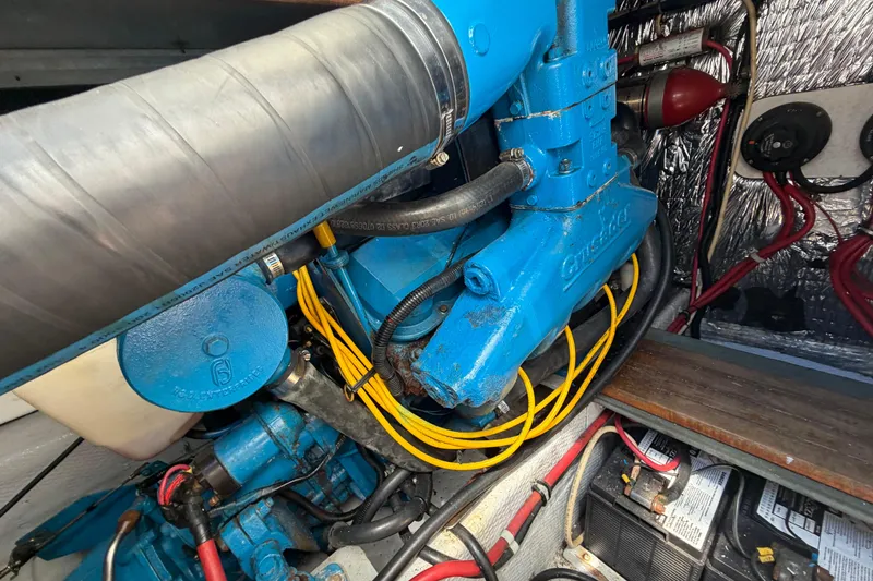 Slide: The Image of Engine compartment of a 1985 Formula 31 Performance Cruiser with blue components and wiring. - 35