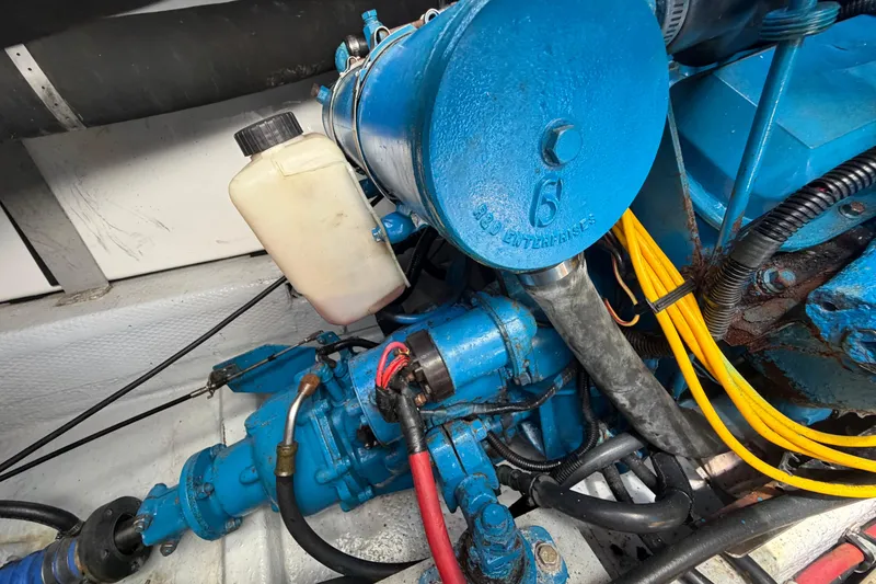 Slide: The Image of Engine compartment of a 1985 Formula 31 Performance Cruiser, featuring blue mechanical components. - 36