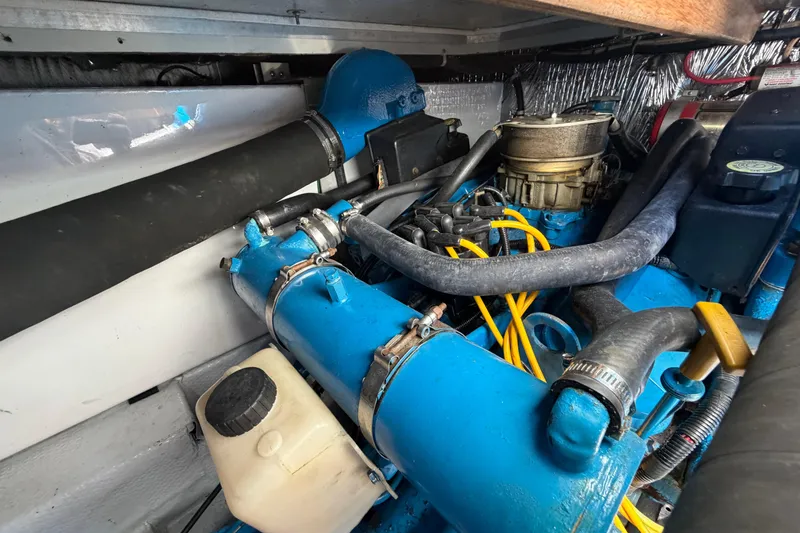 Slide: The Image of Engine compartment of a 1985 Formula 31 Performance Cruiser, showcasing blue engine components. - 37