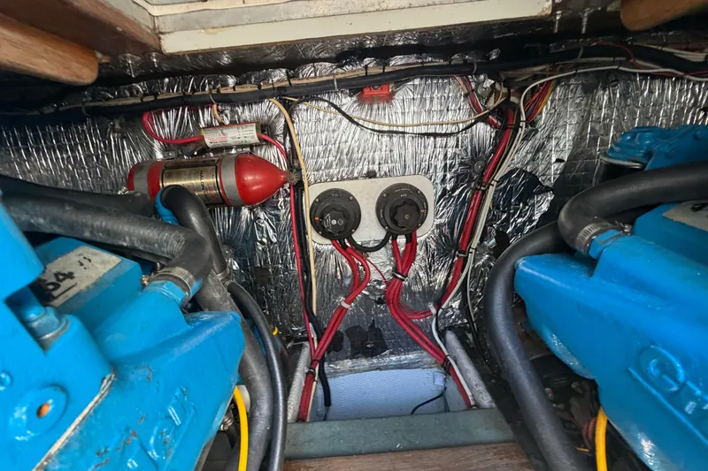 Slide: The Image of Engine compartment of a 1985 Formula 31 Performance Cruiser with wiring and fire extinguisher. - 38