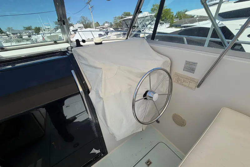 Slide: The Image of 1985 Formula 31 Performance Cruiser helm with covered controls and steering wheel. - 39