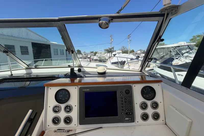 Slide: The Image of 1985 Formula 31 Performance Cruiser cockpit with navigation instruments and marina view. - 41