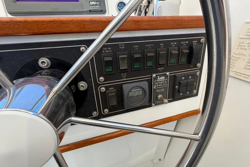 Slide: The Image of Control panel of a 1985 Formula 31 Performance Cruiser with steering wheel and switches. - 43