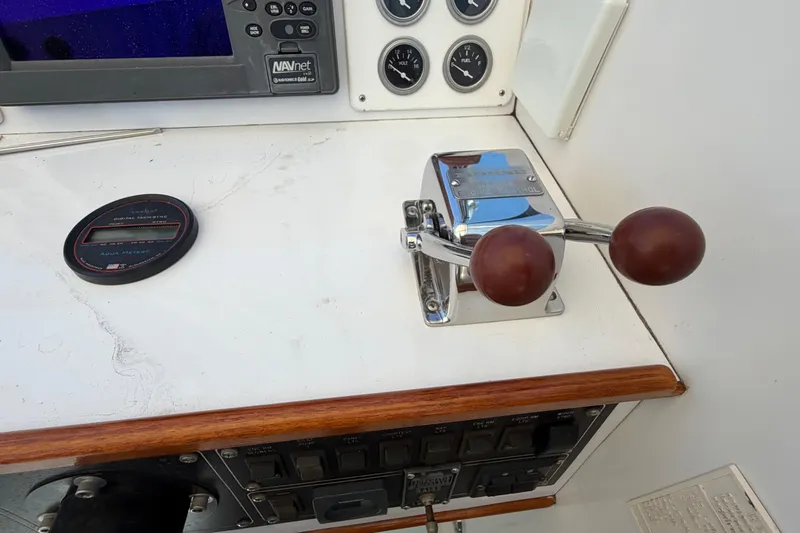 Slide: The Image of Control panel of a 1985 Formula 31 Performance Cruiser with throttle levers and navigation instruments. - 45