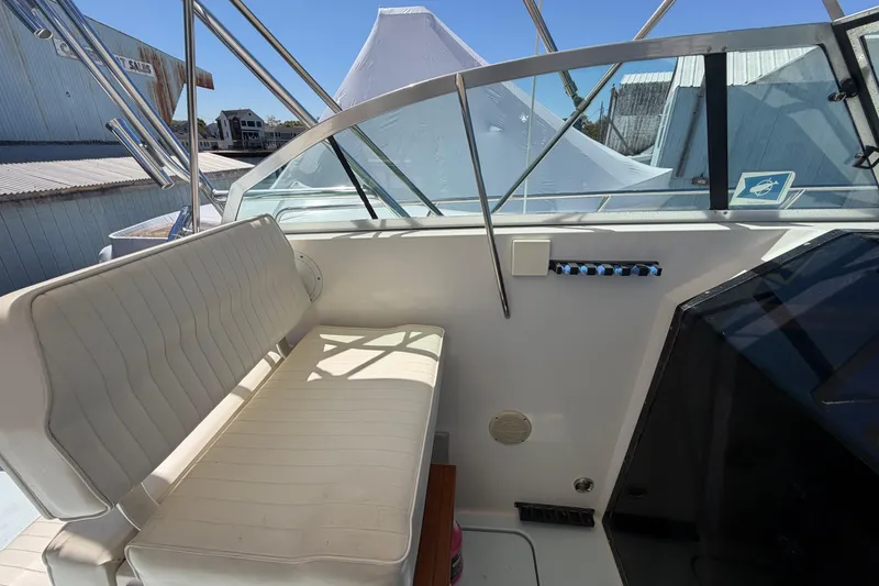 Slide: The Image of 1985 Formula 31 Performance Cruiser cockpit with white seating and clear windshield. - 49