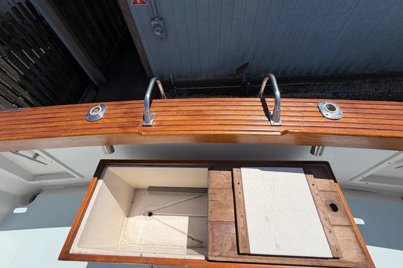 Slide: The Image of 1985 Formula 31 Performance Cruiser deck with wooden finish and storage compartment. - 5