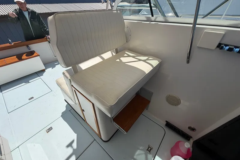 Slide: The Image of 1985 Formula 31 Performance Cruiser interior with white seating and wooden accents. - 50
