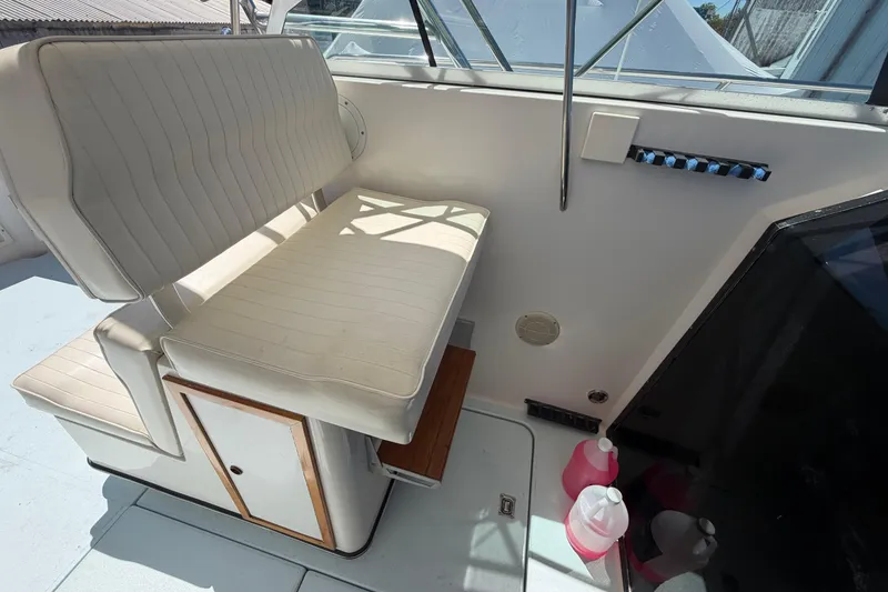 Slide: The Image of 1985 Formula 31 Performance Cruiser interior with white seating and storage compartment. - 51