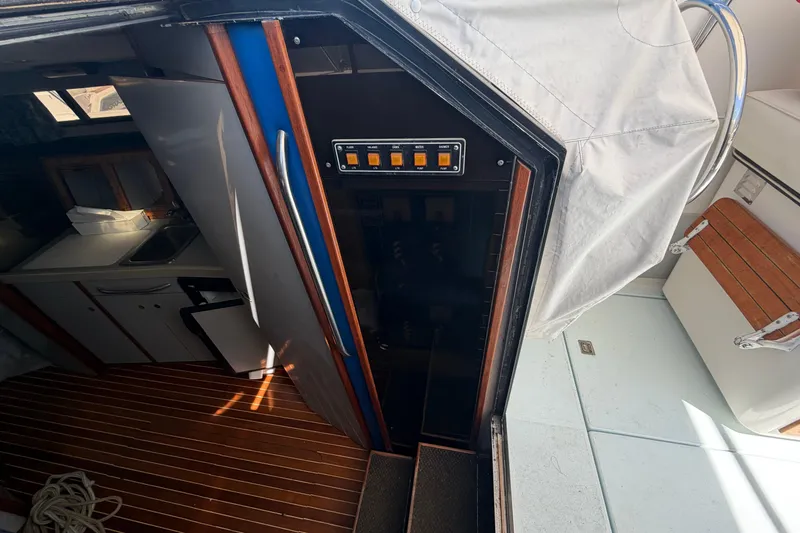 Slide: The Image of Interior view of a 1985 Formula 31 Performance Cruiser, featuring a compact kitchen area. - 53