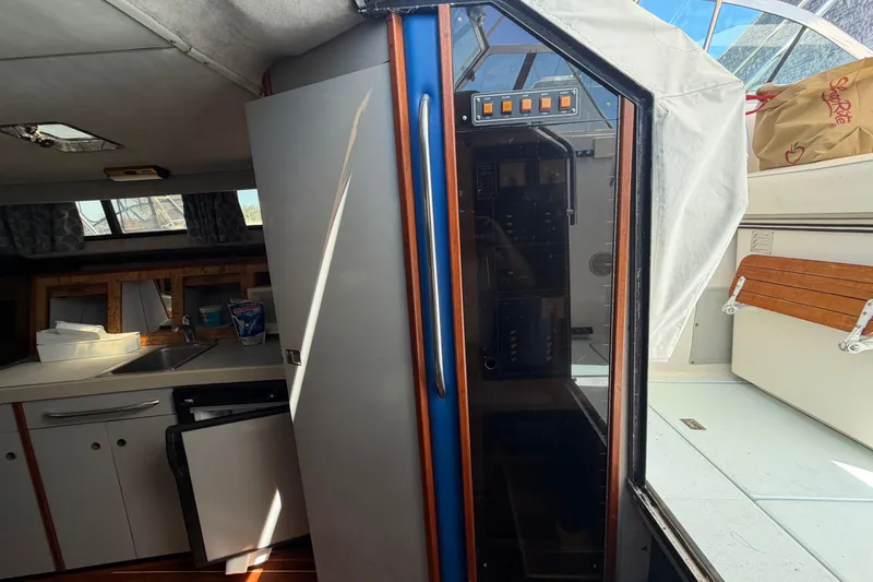 Slide: The Image of Interior of a 1985 Formula 31 Performance Cruiser showing kitchen and seating area. - 56