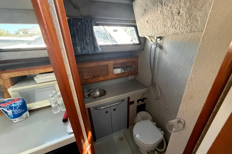 Slide: The Image of 1985 Formula 31 Performance Cruiser bathroom with sink, toilet, and shower. - 60