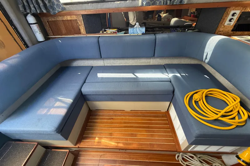 Slide: The Image of Interior of 1985 Formula 31 Performance Cruiser with blue seating and wooden flooring. - 63