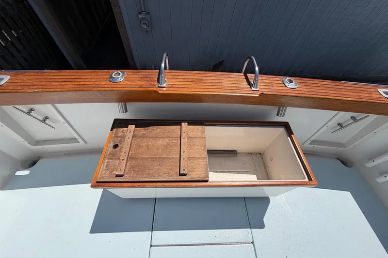 Slide: The Image of 1985 Formula 31 Performance Cruiser deck with wooden storage compartment. - 7