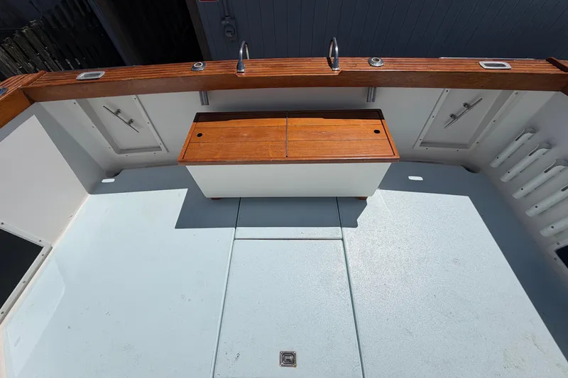 Slide: The Image of 1985 Formula 31 Performance Cruiser cockpit with wooden accents and storage compartments. - 8