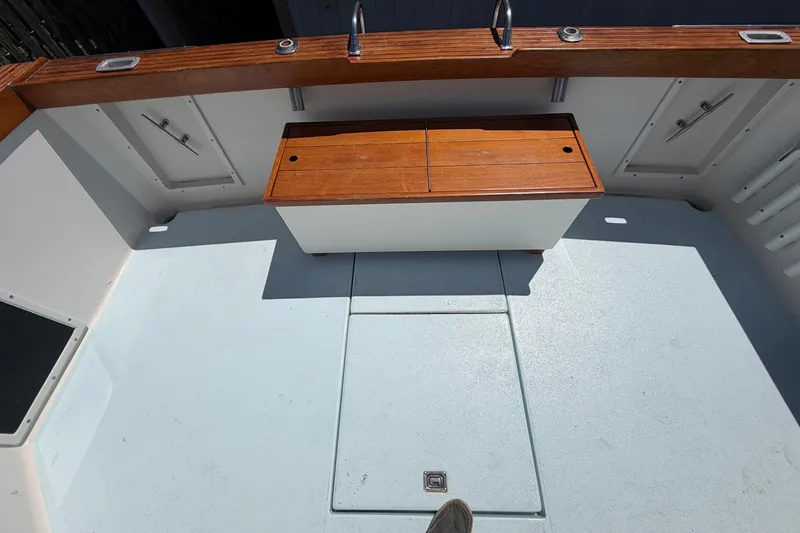 Slide: The Image of 1985 Formula 31 Performance Cruiser deck with wooden storage and clean white flooring. - 9