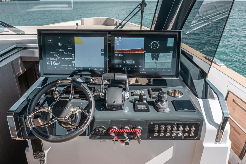 Slide: The Image of Helm of 2026 Fjord 490 SPORT yacht with advanced navigation displays and controls. - 14