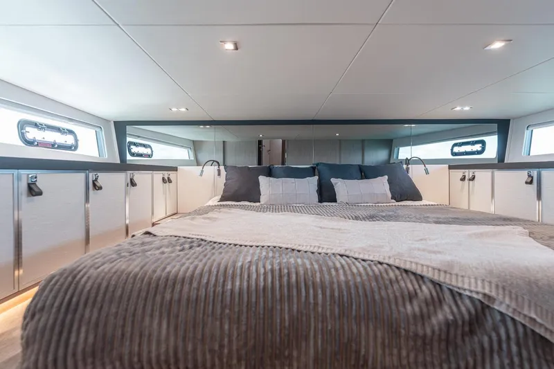 Slide: The Image of Luxurious cabin interior of 2026 Fjord 490 SPORT yacht with plush bedding and modern design. - 17