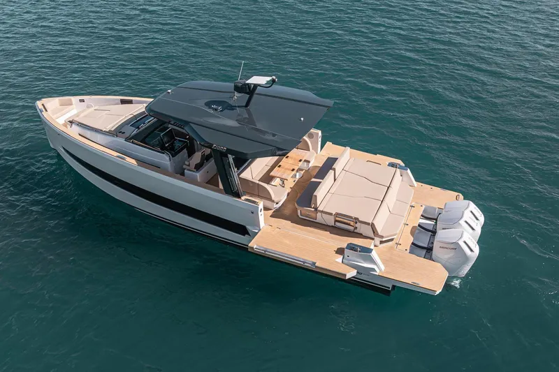 Slide: The Image of 2026 Fjord 490 SPORT luxury boat on open water, showcasing sleek design and powerful engines. - 2