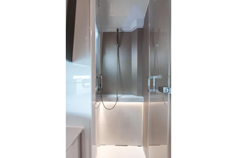 Slide: The Image of Modern shower area in 2026 Fjord 490 SPORT yacht, featuring sleek design and glass doors. - 20