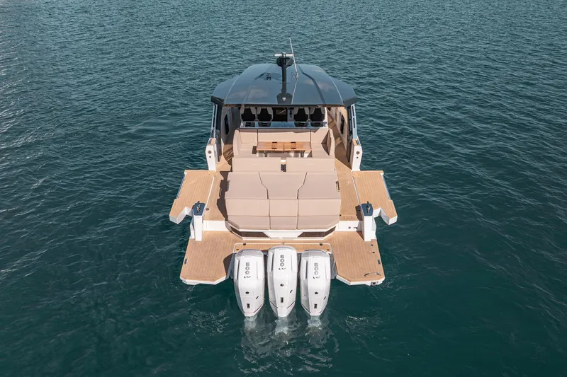 Slide: The Image of 2026 Fjord 490 SPORT luxury boat with triple engines on open water. - 3
