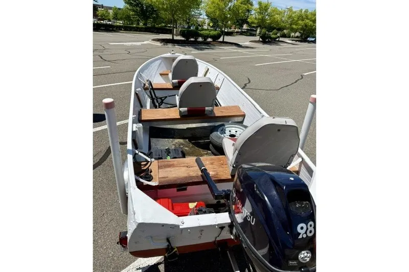 Slide: The Image of 1958 Jon Boat Aluminum model with Tohatsu motor in a parking lot. - 6