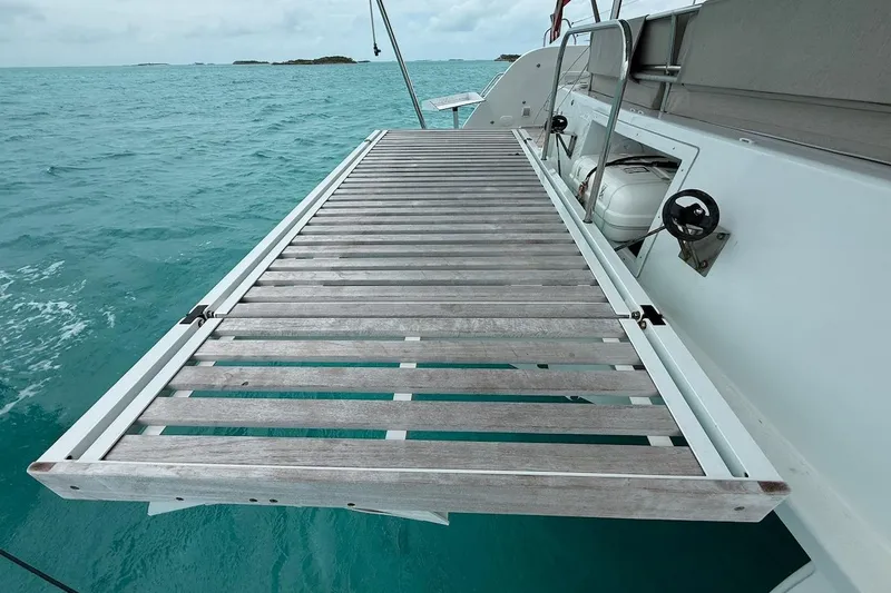 Slide: The Image of Catamaran Lagoon 46 (2022) with wooden deck extension over turquoise sea. - 13
