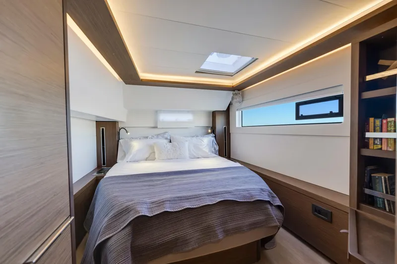 Slide: The Image of Luxurious bedroom interior of 2022 Lagoon 46 yacht with modern lighting and cozy bedding. - 23