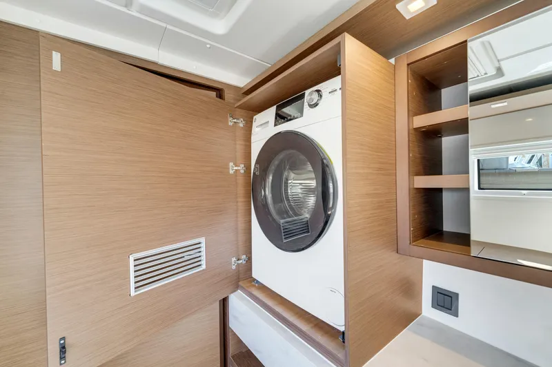 Slide: The Image of Laundry area with a modern washing machine in a 2022 Lagoon 46 yacht. - 25